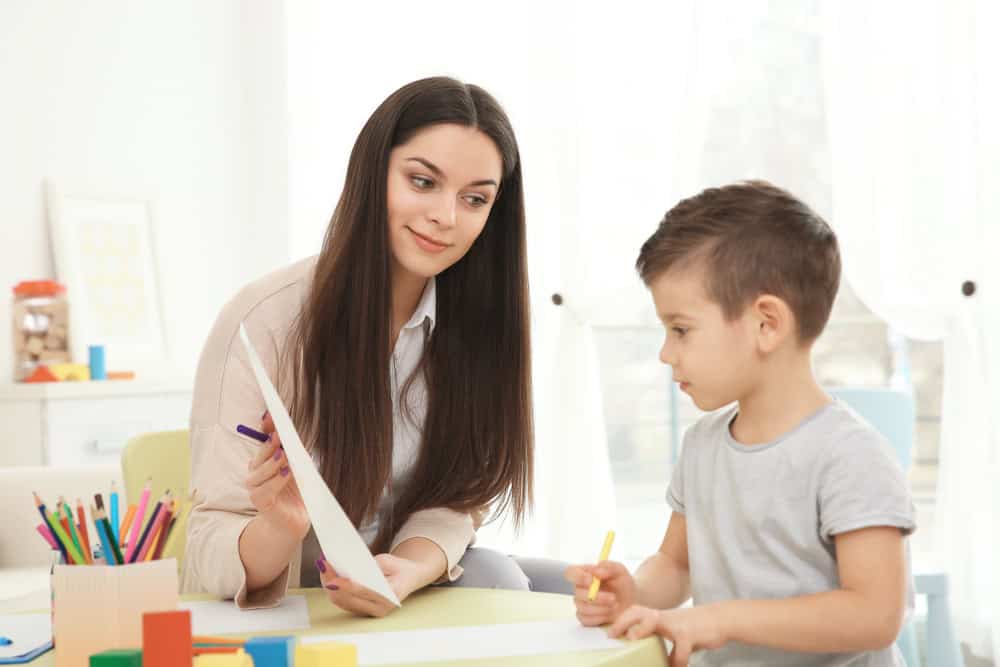 Young Child Psychologist Working With Little Boy